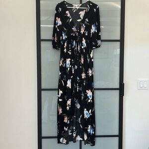 Beachy floral maxi- dress with drawstring tie above waist line. High-low hem.